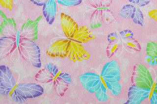 This fabric features colorful butterflies in purple, blue, yellow, white, and green on a pink background.  The fabric has glitter accents to enhance the design.  This lightweight fabric is easy to sew and has a soft hand.   The versatile fabric makes it great for quilting, crafting and home décor.