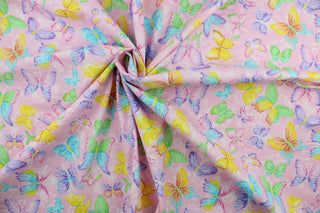 This fabric features colorful butterflies in purple, blue, yellow, white, and green on a pink background.  The fabric has glitter accents to enhance the design.  This lightweight fabric is easy to sew and has a soft hand.   The versatile fabric makes it great for quilting, crafting and home décor.