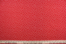Load image into Gallery viewer, This fabric features dainty white bows with polka dots on a solid red background. 
