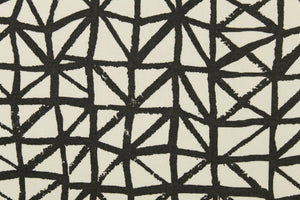 This fabric features a geometric design in black against a white background. 