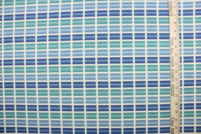 This fabric features a plaid design in shades of blue, green and dull white 