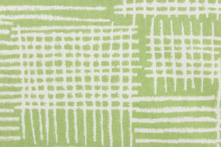 This fabric features a geometric design in a light green and white. 