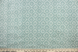 This chenille fabric features a geometric design in light aqua blue, gray and white. 