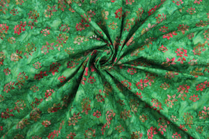 This fabric features small flowers in red, light pink, dark green, brown and light purple on a green background