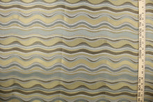 Load image into Gallery viewer,  This fabric features a wavy design in gray, blue, taupe, and gold with a latex backing.
