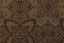 Load image into Gallery viewer, This fabric features a flower or butterfly design in brown, gold, tan, and beige with a latex backing . 
