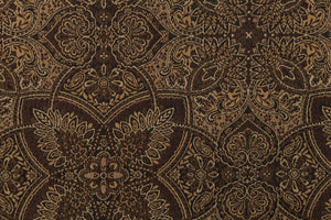 This fabric features a flower or butterfly design in brown, gold, tan, and beige with a latex backing . 
