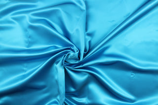  A beautiful satin fabric in a rich turquoise blue color.
