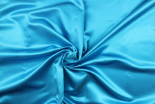 Load image into Gallery viewer,  A beautiful satin fabric in a rich turquoise blue color.
