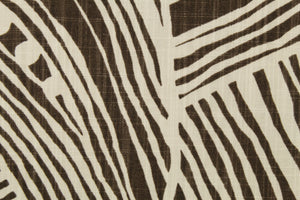 This fabric features an oversized leaf design in brown and off white 