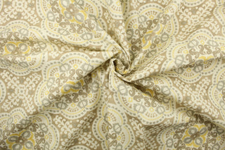 This  fabric features a medallion design in gray, taupe, yellow, and dull white .