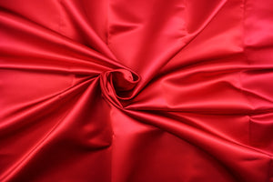  A beautiful satin fabric in a red color . 