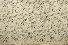 Load image into Gallery viewer,  This fabric features cursive letters in black set against a beige background .
