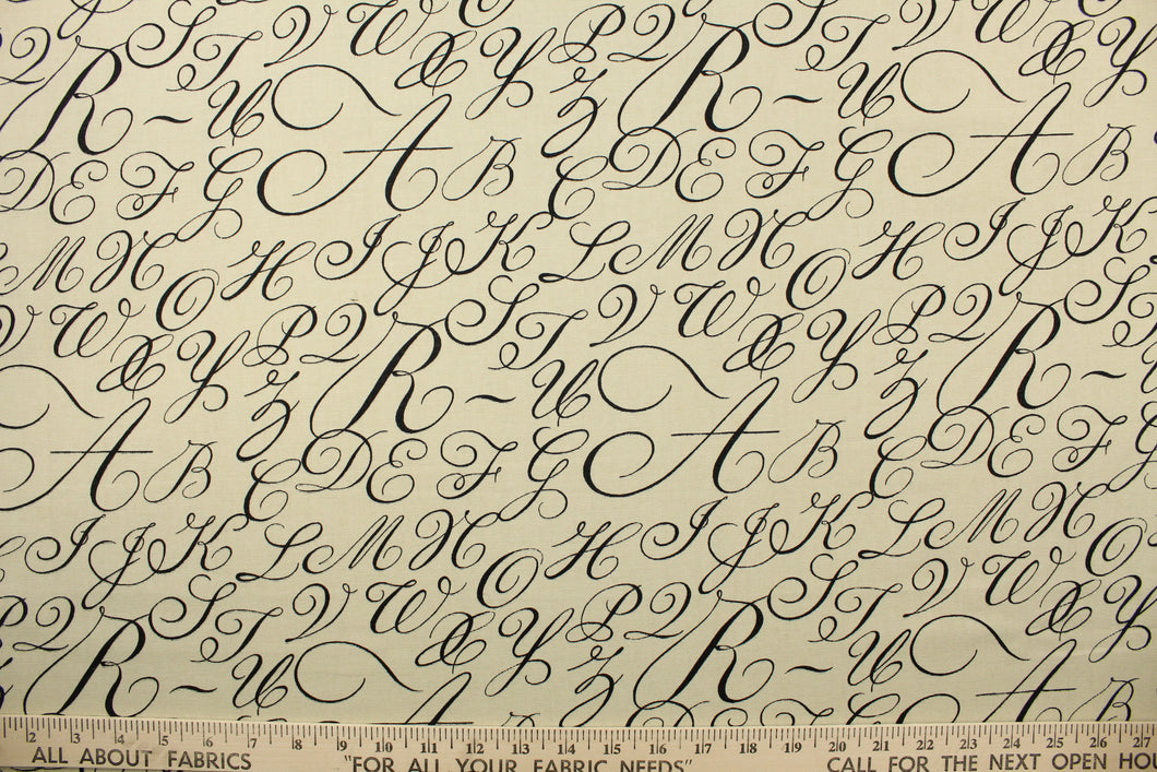  This fabric features cursive letters in black set against a beige background .