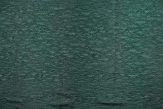 This taffeta fabric features a crinkle in a rich green .