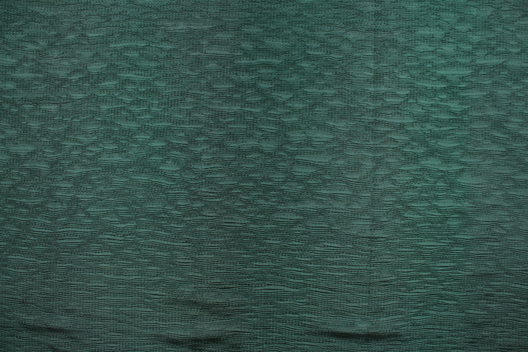 This taffeta fabric features a crinkle in a rich green .