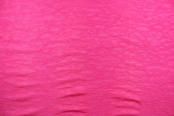 This taffeta fabric features a crinkle design in a hot pink.