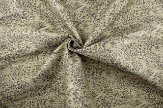 This fabric features a unique design in shades of gray, taupe, and beige with a latex backing.