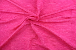 This taffeta fabric features a crinkle design in a hot pink.