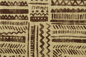This fabric features a tribal design in brown and beige . 