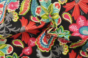  This outdoor fabric features a bright floral design in green, red, turquoise, gray, black, beige, blue, white, hot pink, and a light yellow.