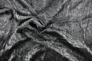 This taffeta fabric features a crinkle in iridescent dark gray.