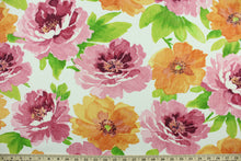 Load image into Gallery viewer, This multi use fabric features a large, floral design in shades of orange, pink and green on a white background.  It is perfect for outdoor settings or indoors in a sunny room.  It is stain and water resistant and can withstand up to 500 hours of direct sun exposure and has a durability rating of 10,000 double rubs.  Uses include decorative pillows, cushions, chair pads, tote bags and upholstery.
