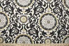 Load image into Gallery viewer, This fabric features an ornamental sun design in gray, white, taupe, and black .
