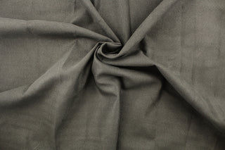 This fabric features a thin chevron design in gray and brown .