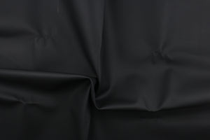  A smooth vinyl fabric in black. 