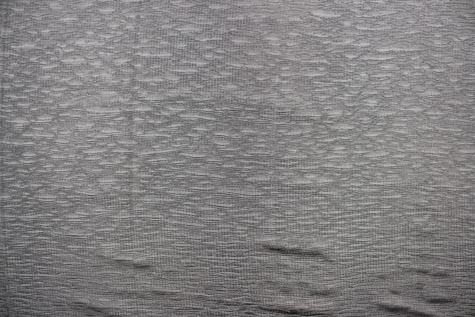 This taffeta fabric features a crinkle in a true gray color .