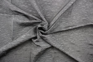 This taffeta fabric features a crinkle in a true gray color .