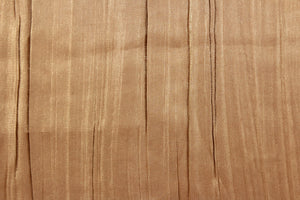 This taffeta fabric features a crinkle in iridescent rich tan with gold shimmer .