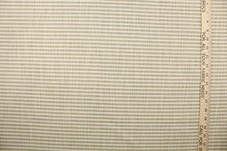 Austere is a horizonal striped fabric in khaki and  off white.  The multi use fabric is perfect for window treatments, decorative pillows, custom cushions, bedding, light duty upholstery applications and almost any craft project.  This fabric has a soft workable feel yet is stable and durable.