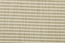 Load image into Gallery viewer, Austere is a horizonal striped fabric in khaki and off white.  The multi use fabric is perfect for window treatments, decorative pillows, custom cushions, bedding, light duty upholstery applications and almost any craft project.  This fabric has a soft workable feel yet is stable and durable.
