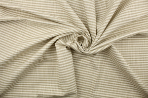 Austere is a horizonal striped fabric in khaki and off white.  The multi use fabric is perfect for window treatments, decorative pillows, custom cushions, bedding, light duty upholstery applications and almost any craft project.  This fabric has a soft workable feel yet is stable and durable.