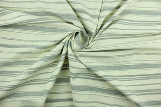 This fabric features stripes in gray on a natural background.  It can be used for several different statement projects including window accents (drapery, curtains and swags), decorative pillows, hand bags, bed skirts, duvet covers, light duty upholstery and craft projects.  It has a soft workable feel yet is stable and durable.  We offer this design in several different colors.