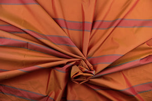 This sheer fabric features a stripe design in deep orange. red, and a blue gray color. 