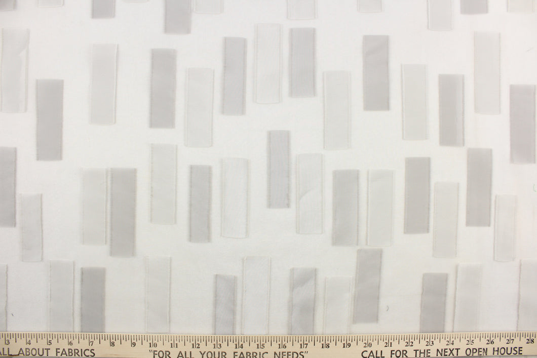 This sheer fabric features a geometric design in pale grays. 