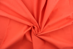 Poplin fabric in a solid orange. 