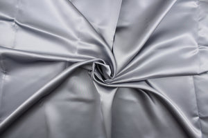 A beautiful satin fabric in a silver color.