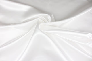 A beautiful satin fabric in a bright white color.