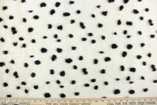 Load image into Gallery viewer, This faux fur features a dot design in black against white. 
