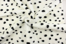 Load image into Gallery viewer, This faux fur features a dot design in black against white. 
