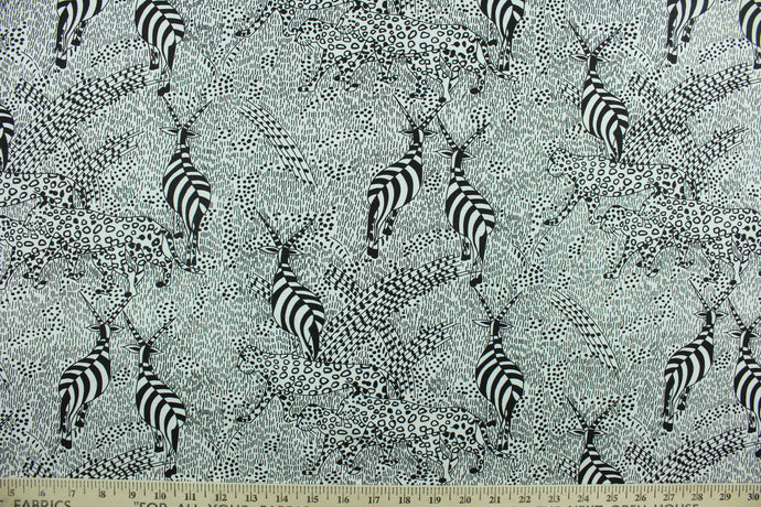 This black and white design features cheetahs and gazelles against an abstract background.  The versatile lightweight fabric is soft and easy to sew.  It would be great for quilting, crafting and sewing projects.  