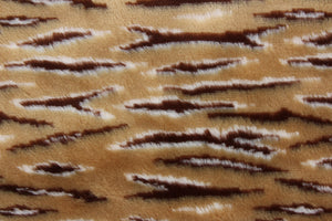 This faux fur features a  stripe design in brown, tan and hints of white . 