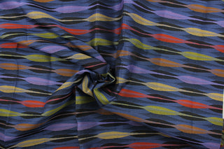 This fabric features a geometric  design in purple, orange, green, golden tan, black, and blue.