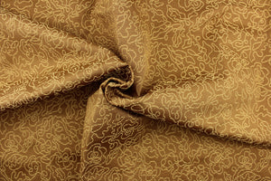  This fabric features a floral design in gold against a golden tan.
