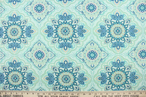 This outdoor fabric features a medallion design in blues, beige, white, turquoise, mint green, and pale green . 