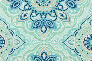 This outdoor fabric features a medallion design in blues, beige, white, turquoise, mint green, and pale green . 